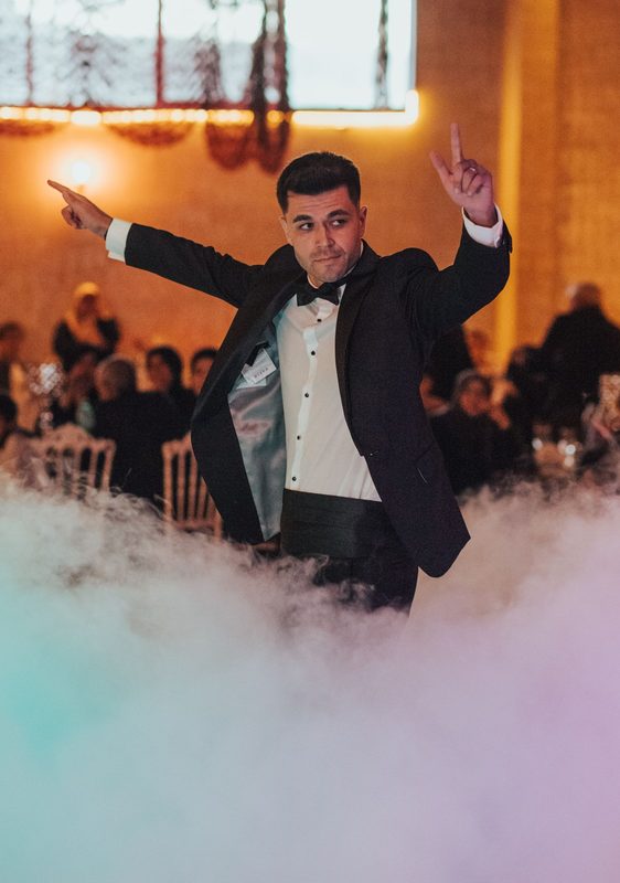 Groom dancing through the haze at a wedding reception – The Jaded live
